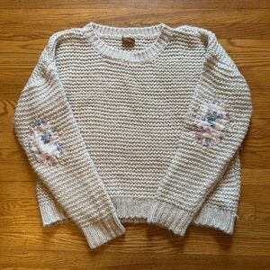 Cream knit sweater with floral patch elbows